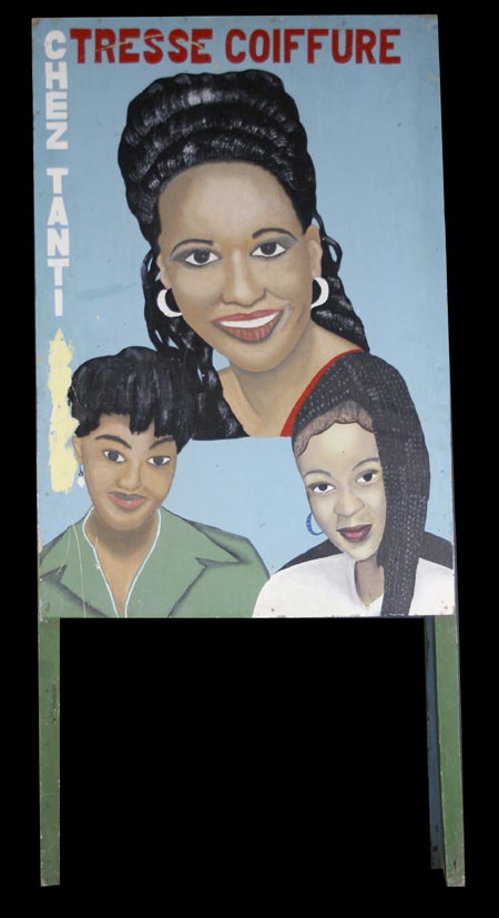 3 women's heads hand-painted on one side of a sandwich sign advertising the Chez Tanti salon, side B