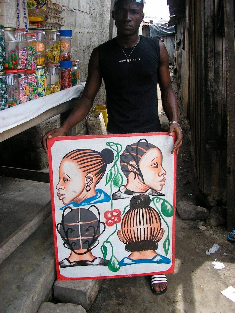 Painted by Joel in Adjame, Abidjan, 4 women's heads on a white background, man for perspective