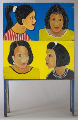 4 women's heads on one side of a sandwich style sign advertising a beauty salon
