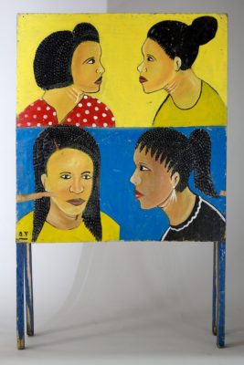 4 women's heads on one side of a sandwich style sign advertising a beauty salon